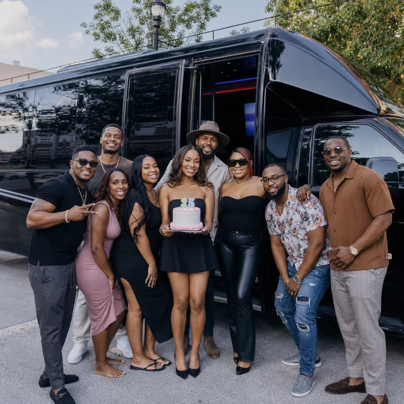Group boarding a white charter bus for Birthday Transportation transportation in Augusta