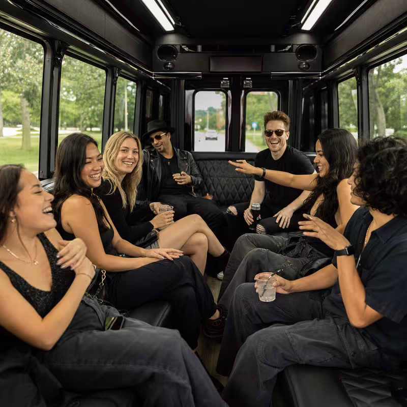 Group boarding a white charter bus for Concert Transportation transportation in Augusta