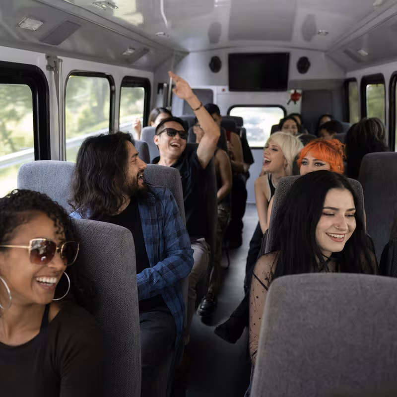 Party bus interior with wraparound leather seating and LED lighting in Augusta