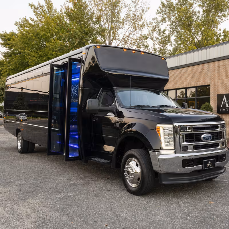 Party bus interior with wraparound leather seating and LED lighting in Augusta