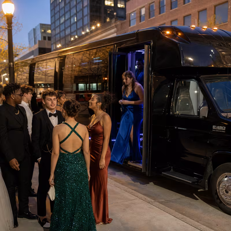 Passengers loading luggage while boarding an Augusta group shuttle