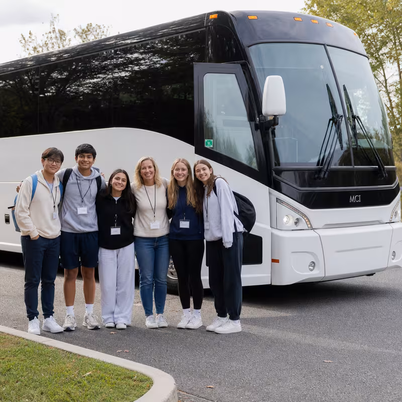 Passengers loading luggage while boarding an Augusta group shuttle