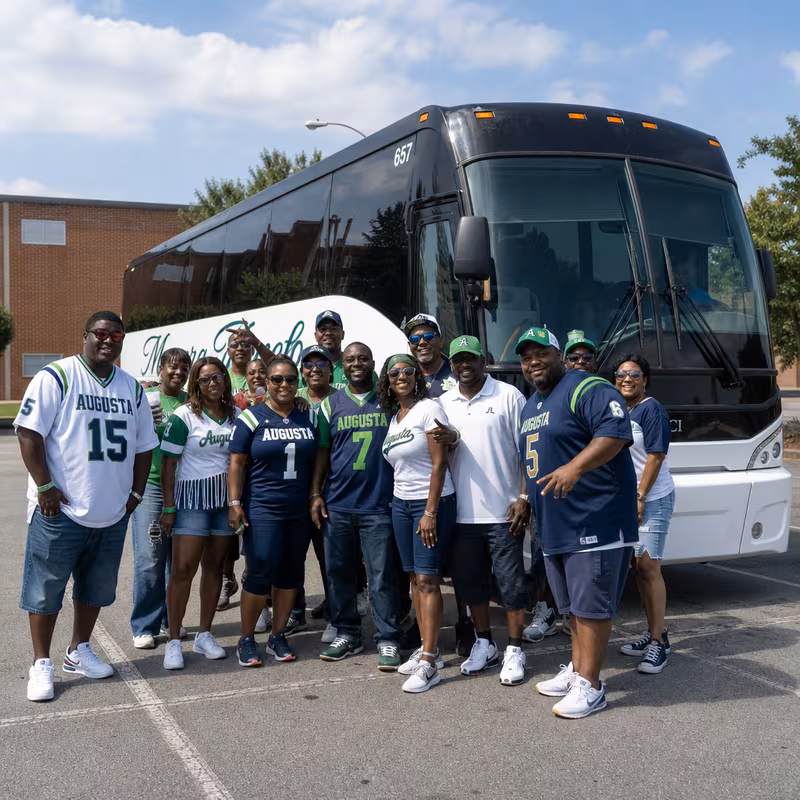 Passengers loading luggage while boarding an Augusta group shuttle