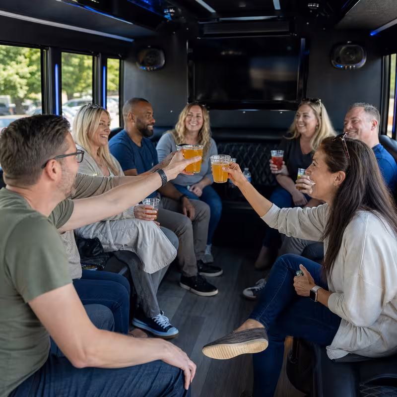 Group boarding a white charter bus for Winery & Brewery Tour Transportation transportation in Augusta