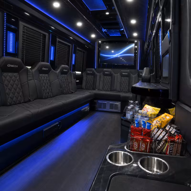 Party bus interior with wraparound leather seating and LED lighting in Augusta