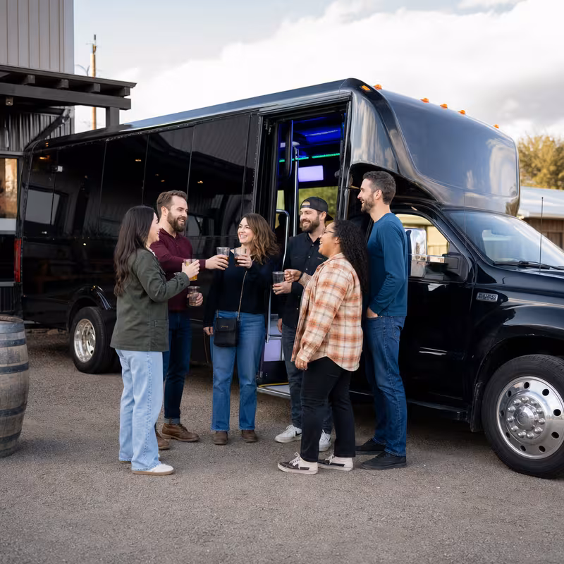 Passengers loading luggage while boarding an Augusta group shuttle